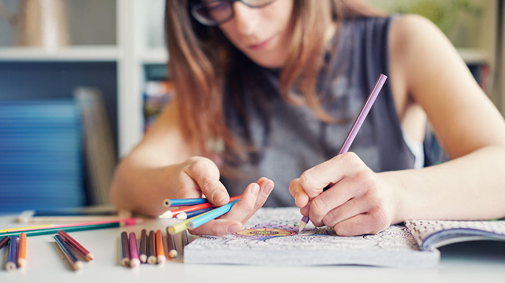 Crafting for mental health; woman colouring in